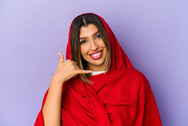 Young indian woman wearing a hijab isolated showing a mobile phone call gesture with fingers.