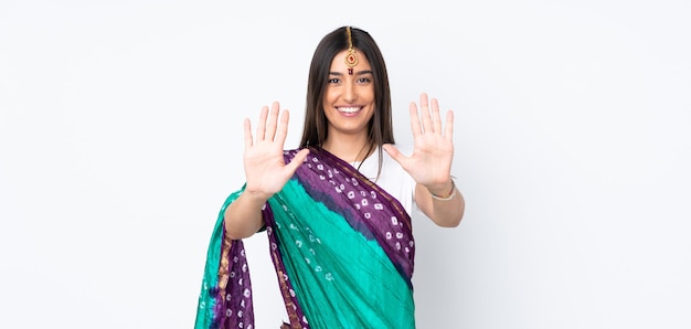 Young Indian woman on white counting ten with fingers