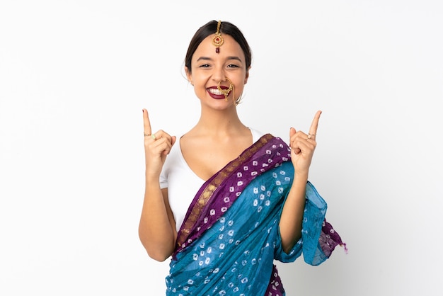 Young indian woman on white wall pointing up a great idea