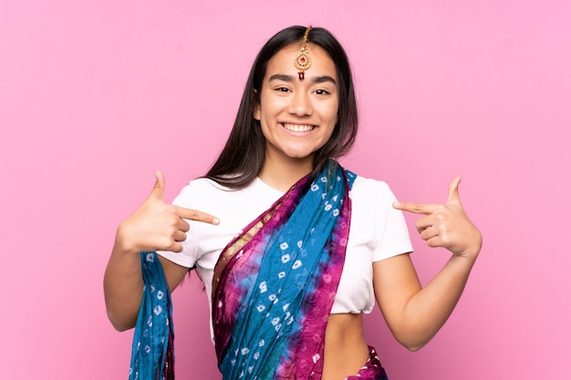 Young Indian woman with sari over isolated wall proud and self-satisfied