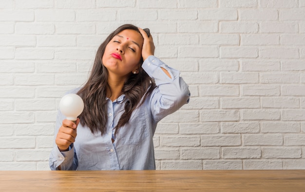 Young indian woman worried and overwhelmed, forgetful, realize something.