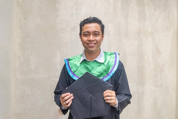 Photo young indonesian guys celebration and cheers when graduation moment