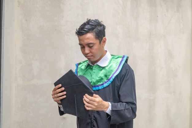 Young Indonesian guys celebration and cheers when graduation moment