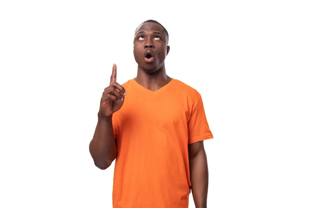 young inspired smart african man dressed in orange tshirt tells the news