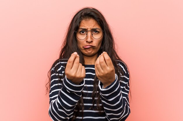 Young intellectual indian woman showing that he has no money.