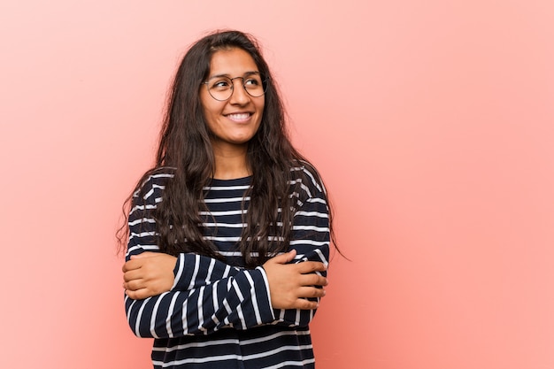 Young intellectual indian woman smiling confident with crossed arms.