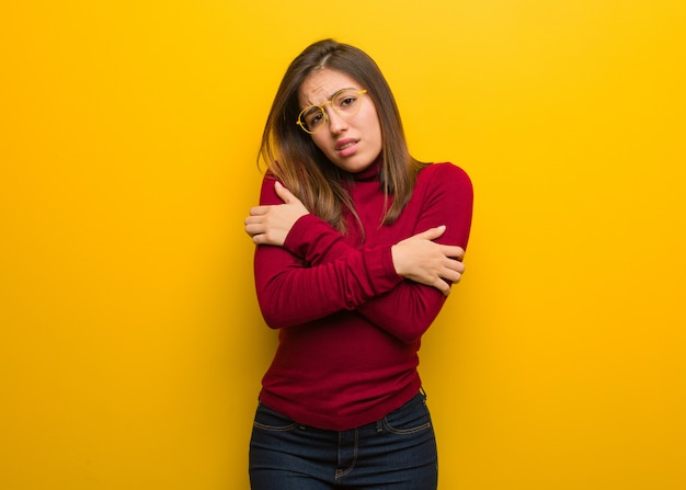 Young intellectual woman going cold due to low temperature