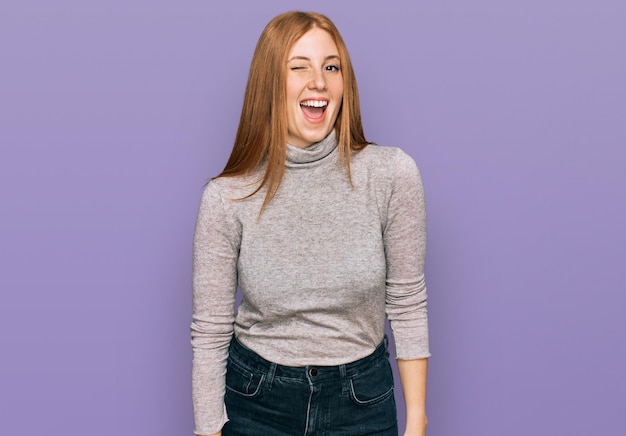 Young irish woman wearing casual clothes winking looking at the camera with sexy expression cheerful and happy face