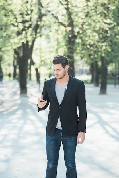 A young italian boy using a smartphone