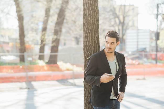 A young italian boy using a smartphone