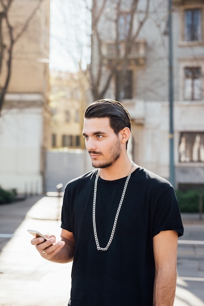 A young italian boy using a smartphone