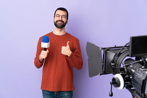 Young journalist man over isolated wall