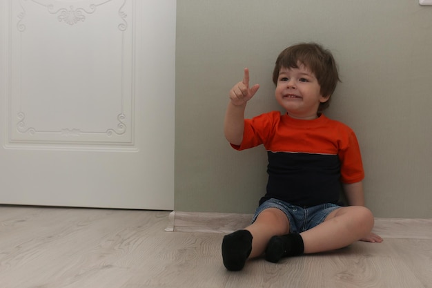 Young kids playing on a floor in a room