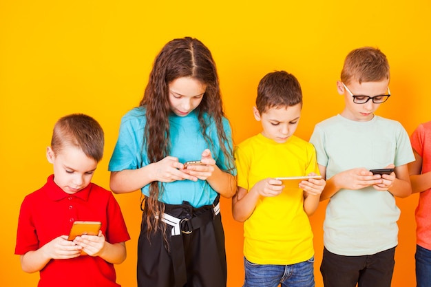 Photo young kids playing game on mobile phone