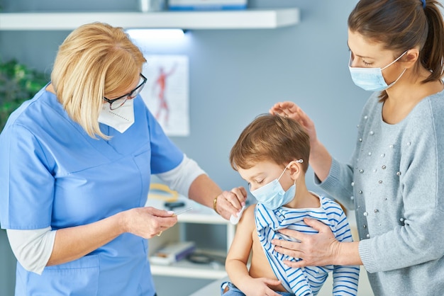 Young kids during vaccination in hospital. High quality photo