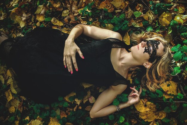 A young kind witch in a black dress