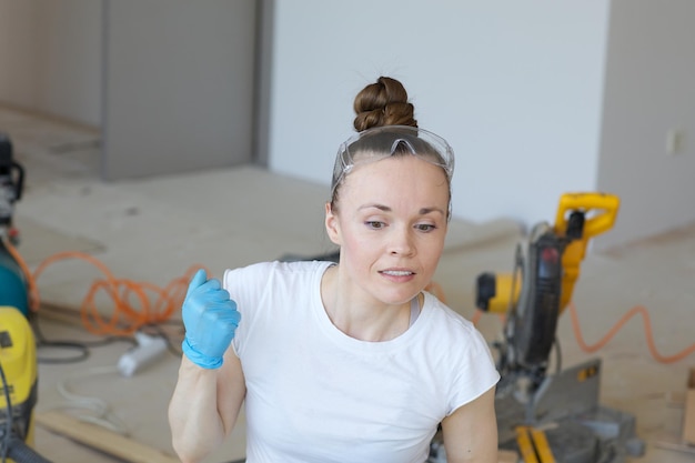 Young lady between 30 and 40 years old is dealing with plinth installation