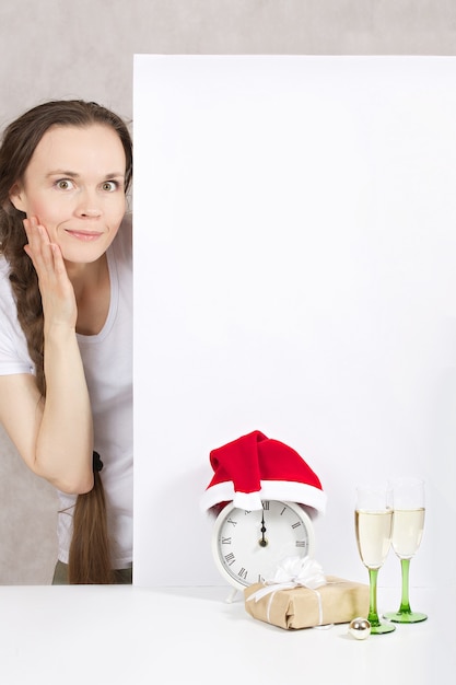 Young lady between 30 and 40 years in Santa Claus hat