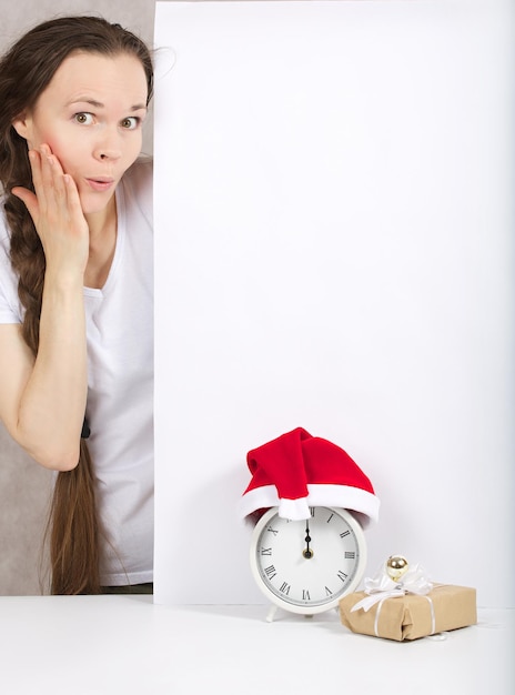 Young lady between 30 and 40 years in Santa Claus hat