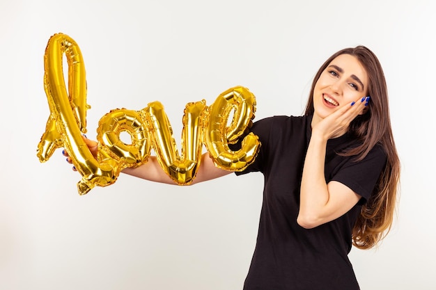 Young lady holding balloon and seems grateful