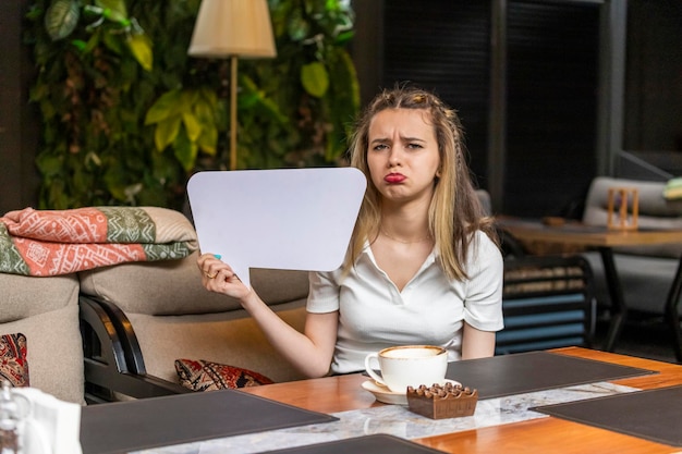 Young lady holding idea board and feeling sad