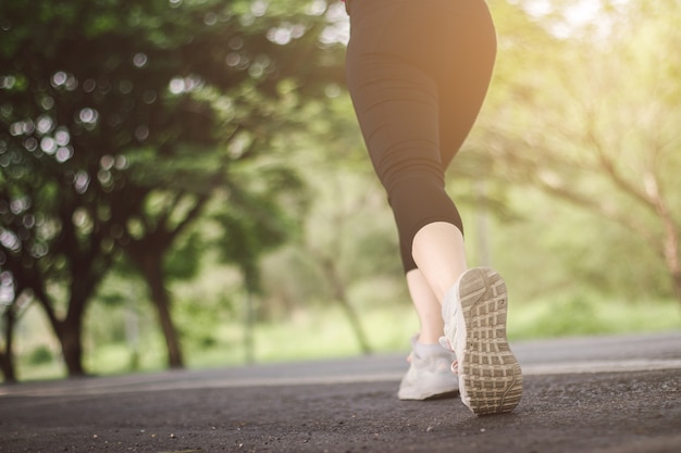 Young lady is running on the road