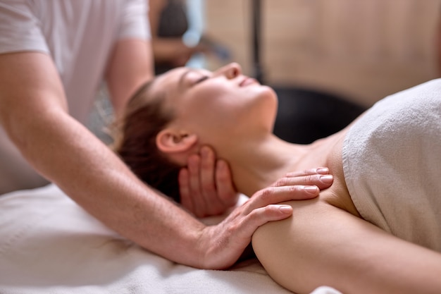 Young lady relax during spa massage in beauty center