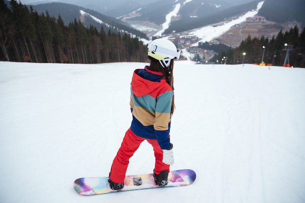 Young lady snowboarder on the slopes frosty winter day