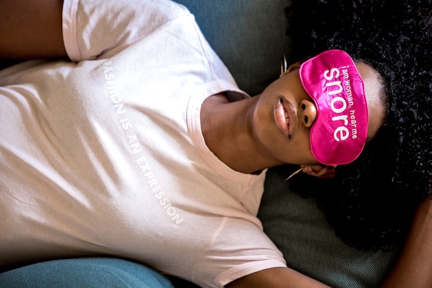 Young lady using eye mask for sleep