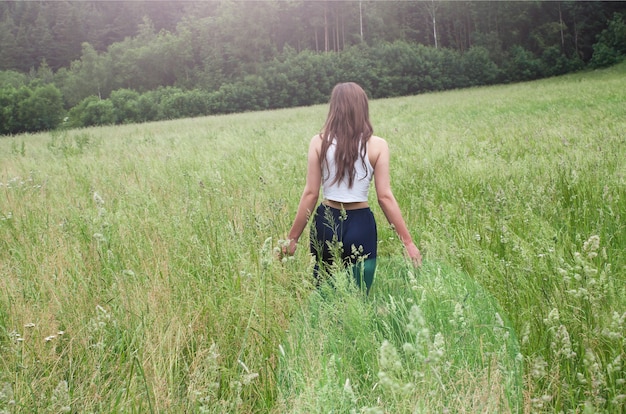 Young lady walking in field