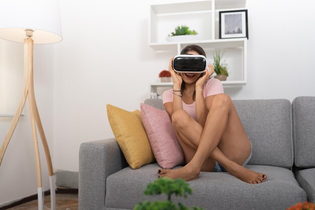 Young lady watching videos with her virtual reality glasses