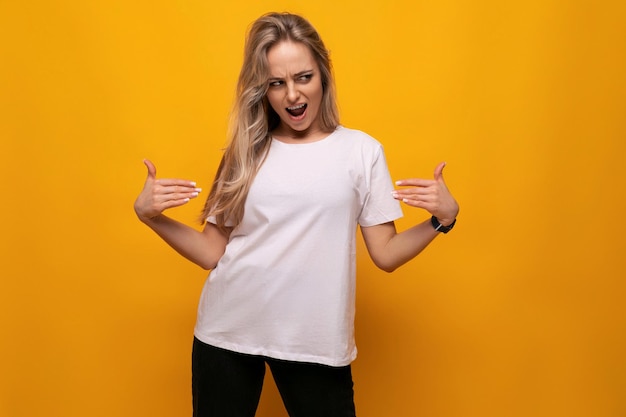 Young lady in a white tshirt mocap on a yellow background
