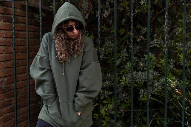 Young latin american girl with hoodie and sunglasses