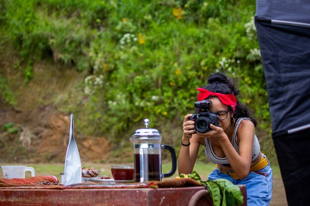 young Latin American photographer photographing coffee in the mountains of the Peruvian jungle