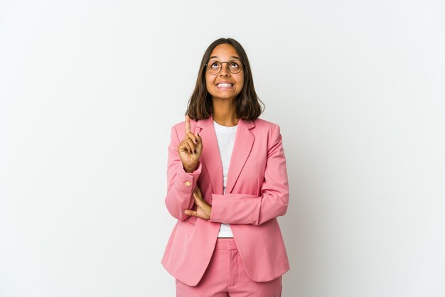 Young latin business woman isolated on white wall being shocked due to an imminent danger