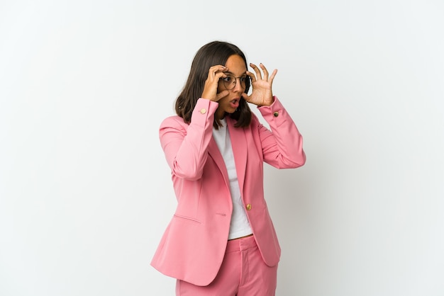 Young latin business woman isolated on white wall unhappy  with sarcastic expression.