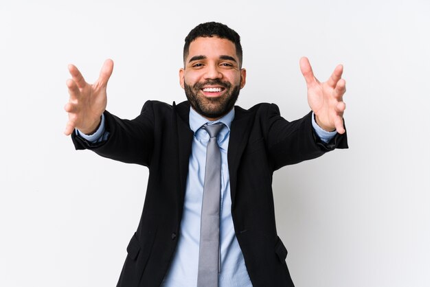 Young latin business woman on a white isolated feels confident giving a hug