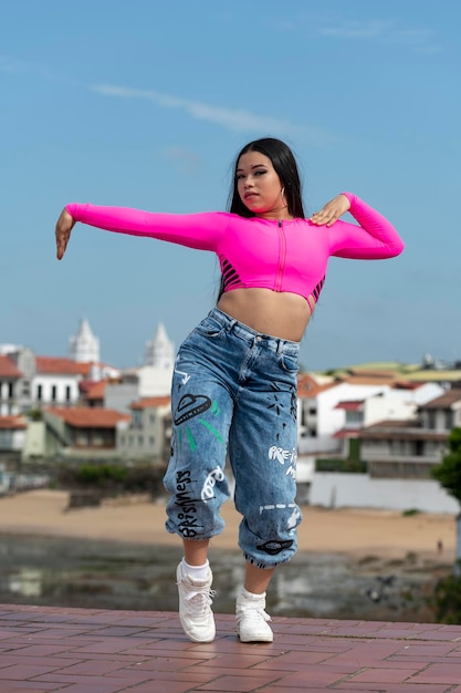 Young latin girl dancing in the street panama stock photo