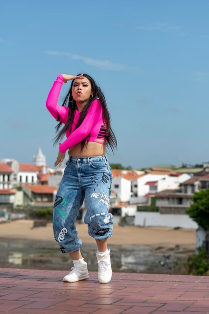 Young latin girl dancing in the street Panama stock photo