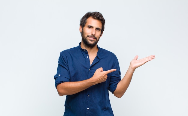 Young latin handsome man in shirt isolated