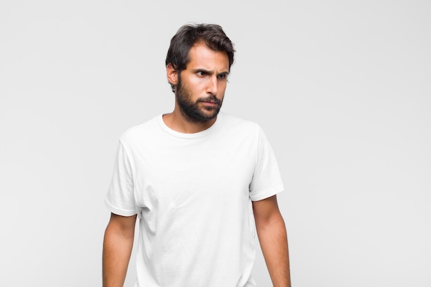 Young latin handsome man in t-shirt isolated