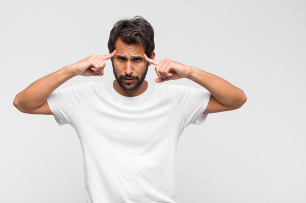 Young latin handsome man in t-shirt isolated