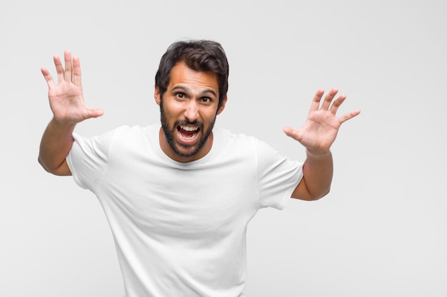 Young latin handsome man in t-shirt isolated