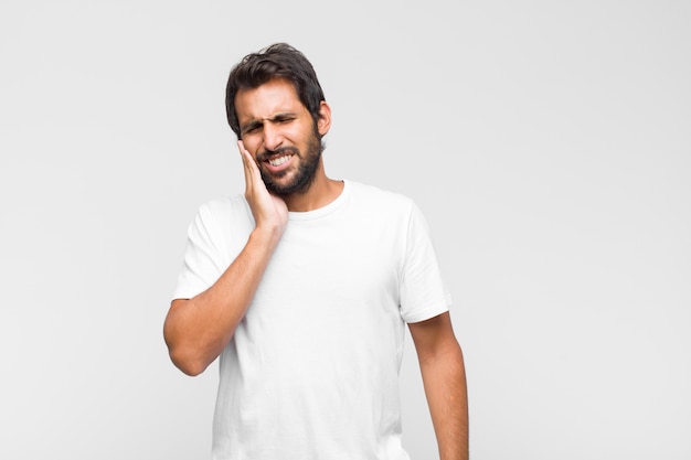 Young latin handsome man in t-shirt isolated