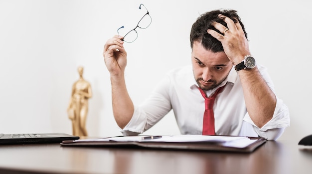 Young Latin male lawyer or employee working night in the office