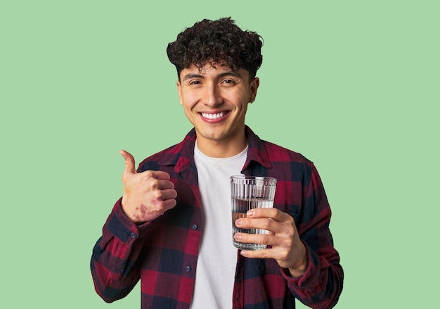 Young latin man holding a water glass