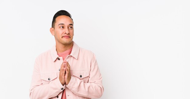 Young latin man posing making up plan in mind