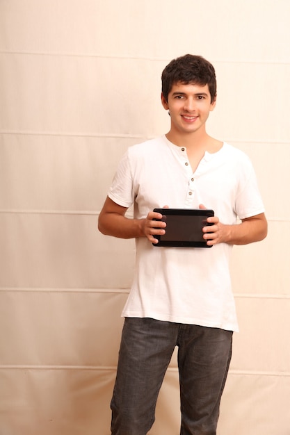 A young, latin man with a Tablet PC