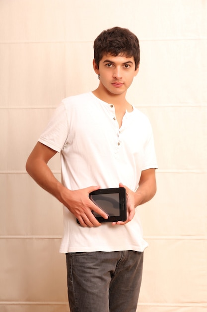 A young, latin man with a Tablet PC