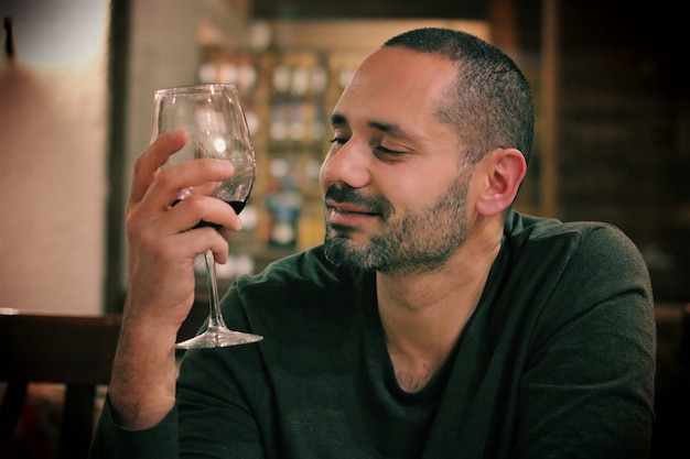 young latin model drinking a glass of wine